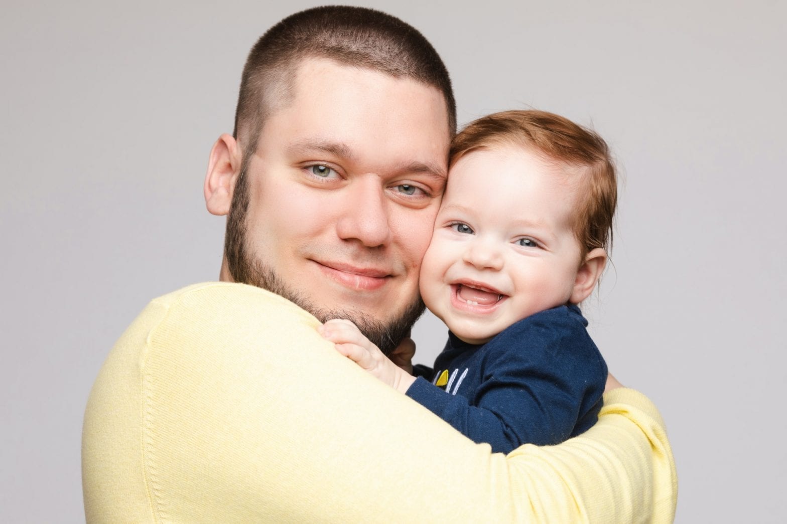 Portrait of happy father posing with lovely smiling child