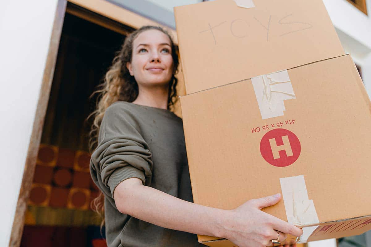 Woman carrying moving boxes