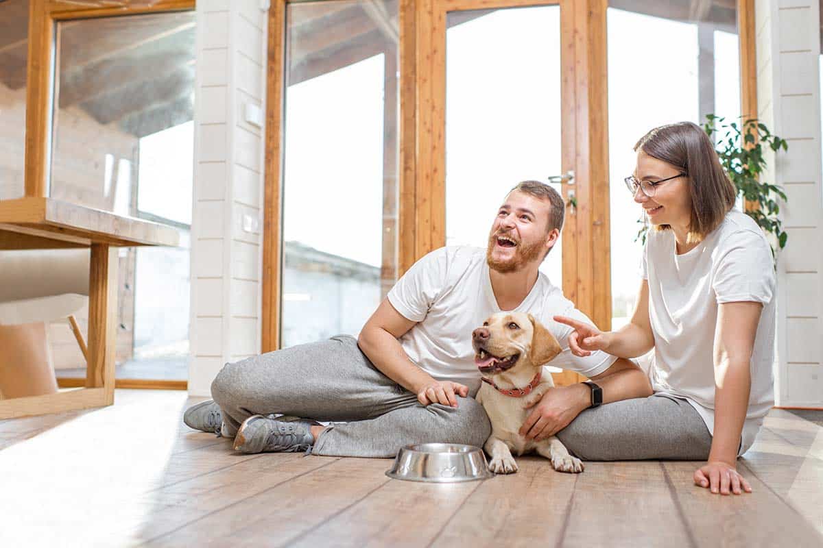 Couple with dog in the house