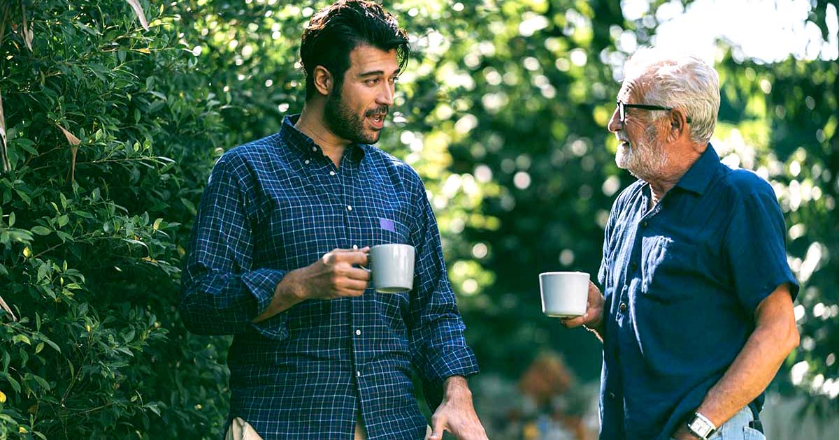 father and son having coffee and talking