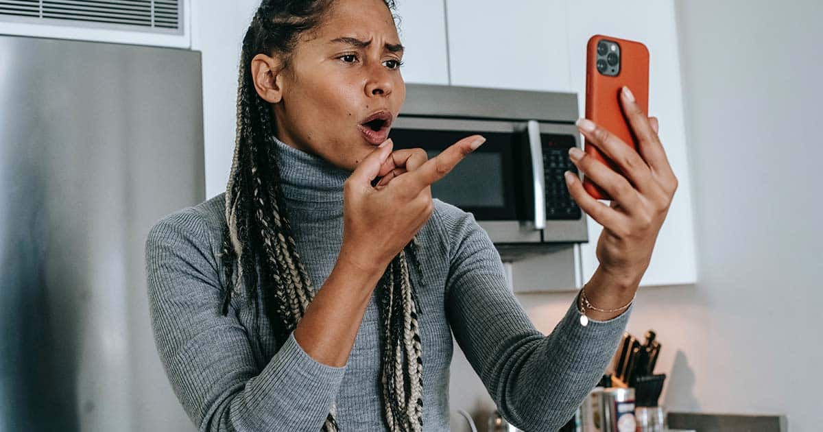 woman is angry at what she saw on a cellphone
