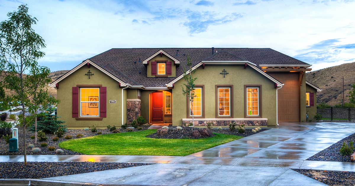 suburban house painted olive at dusk
