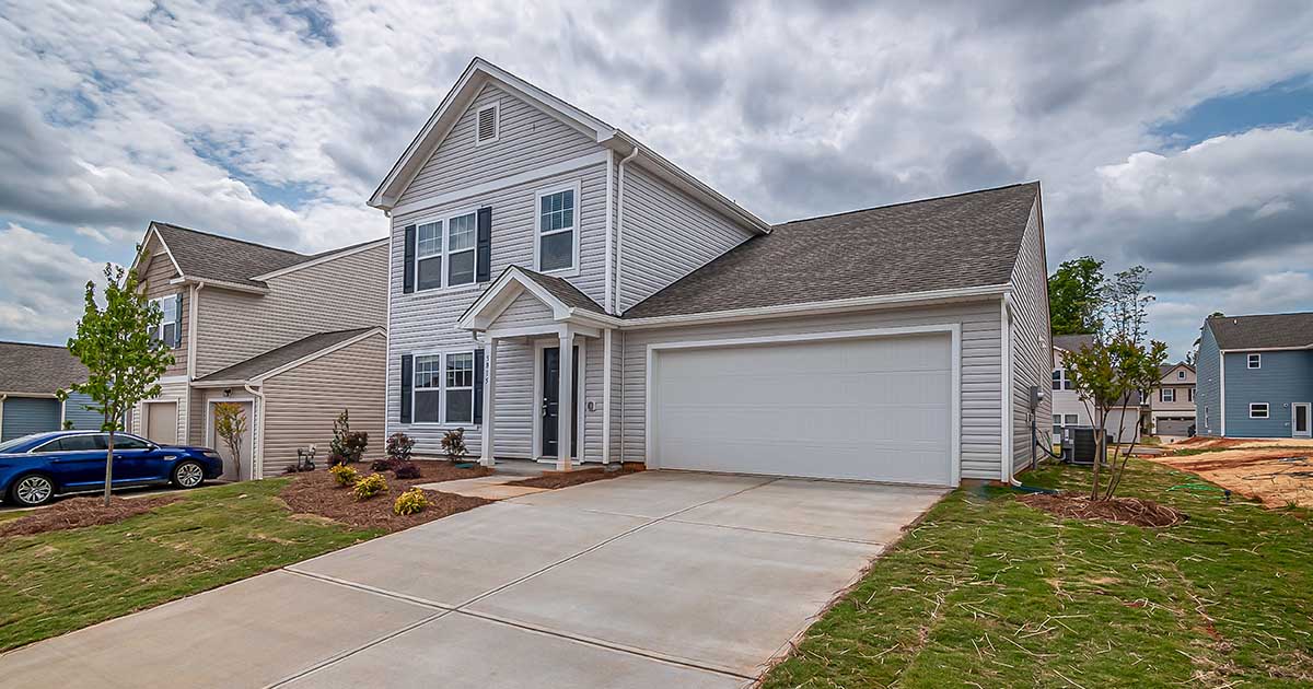 Suburban house with car at the driveway