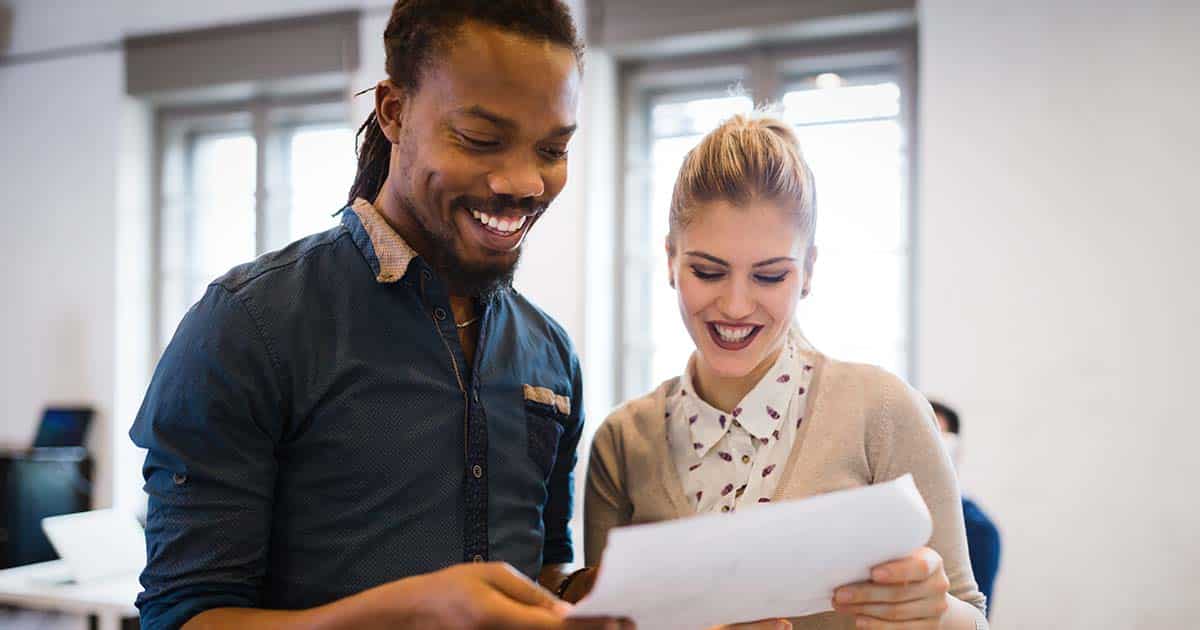 Portrait of young couple discussing in office